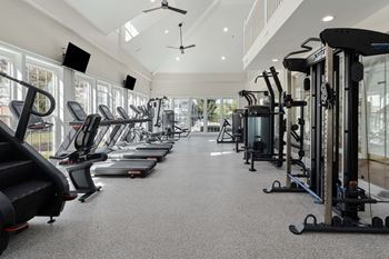 A spacious gym with a variety of cardio machines.